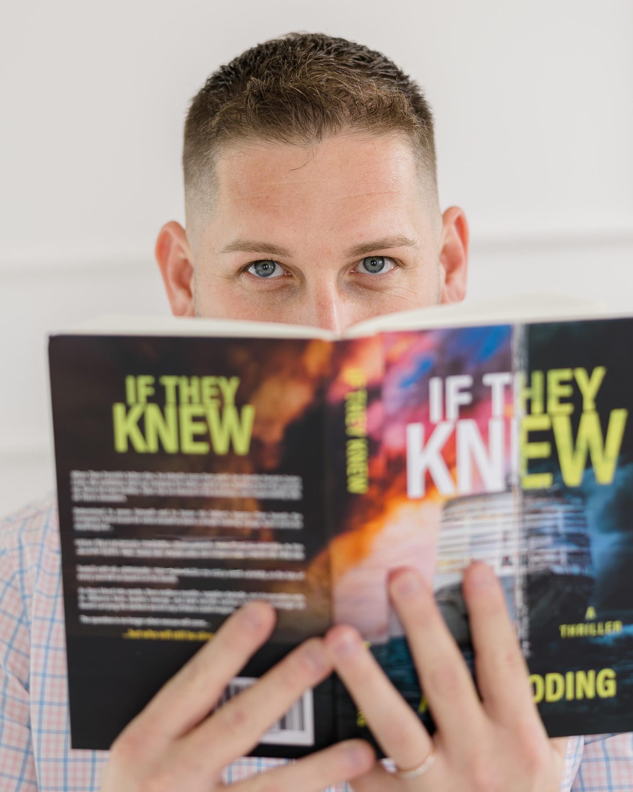 A.J. Wooding holding a copy of If They Knew